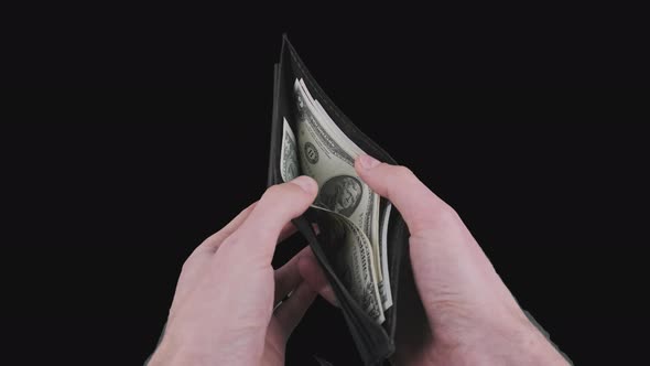 Male Hands Show a Black Wallet with Some Dollar Bills on Alpha Channel