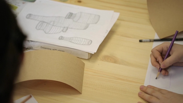 Young Woman Practices In Drawing Three-dimensional Figures In Art Studio