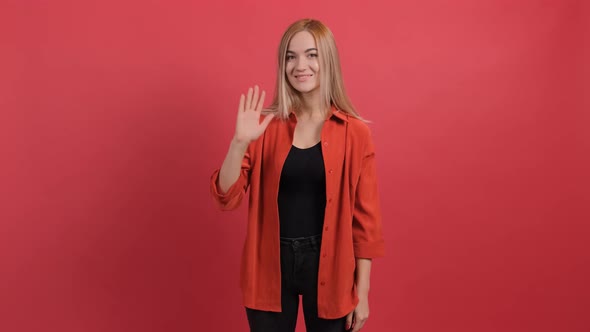 Friendly Beautiful Woman Saying Hi and Smiling Welcoming Friends with Hand