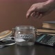 Businessman Puts Money in Glass with Savings - VideoHive Item for Sale