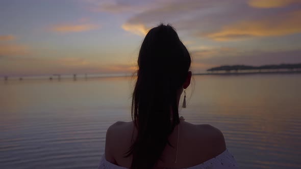 Cute Smiling Asian Woman Walking in the Sea at Beautiful Sunset Thailand