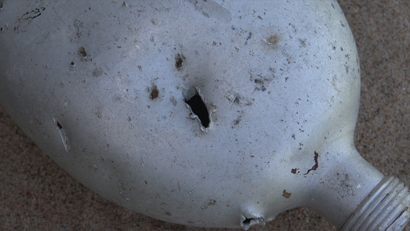 Shells and Bullets Holes in the Watter Canteen alt