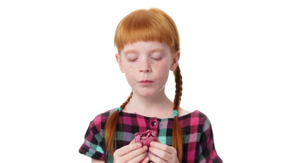 Little  Redhead Girl Is Eating a Makaron