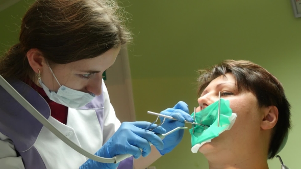 Woman Receiving A Dental Treatment