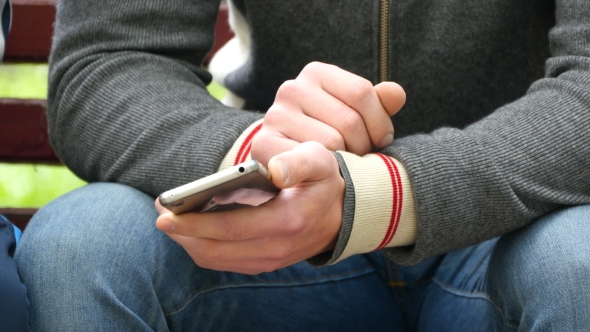 Man With a Smartphone In His Hands Shows Something To Another Person And Gesturing.