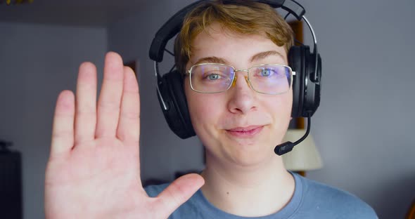 A Teenager Boy in a Headset is Broadcasting Video From Home