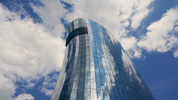 Office Building Skyscraper in the Windows of which reflected the passing clouds