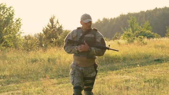 Tired Soldier With Automaton In Hands Goes On The Path