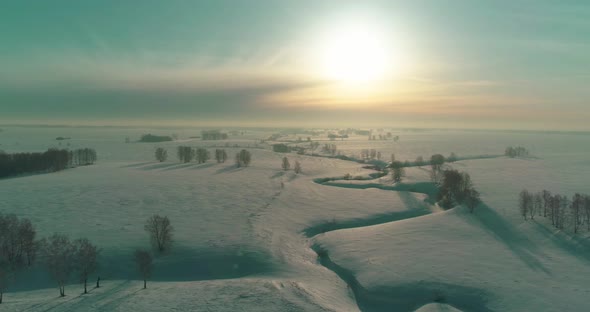 Aerial View of Cold Winter Landscape Arctic Field Trees Covered with Frost Snow Ice River and Sun