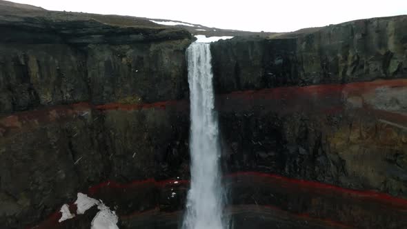 Aerial View on Hengifoss Waterfall with Red Stripes Sediments