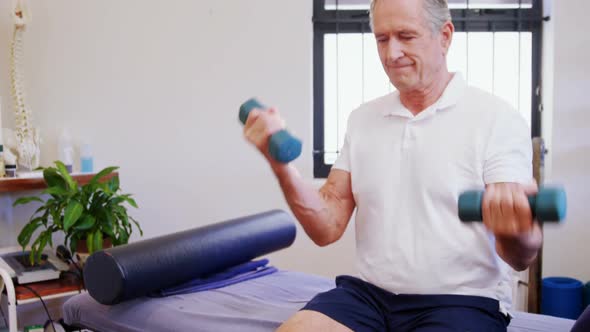 Senior man exercising with dumbbells