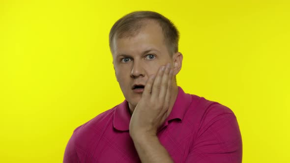 Portrait of Young Caucasian Man Posing in Pink T-shirt. Worried Handsome Guy Shocked, Afraid, Scared