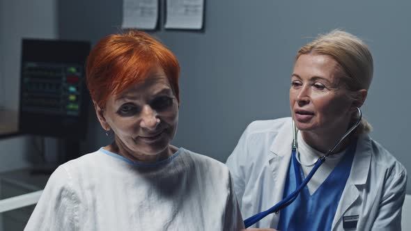 Doctor Using Stethoscope on Patient