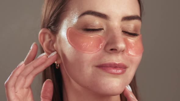 Skin Care Relaxed Woman with Hydrogel Eye Patches
