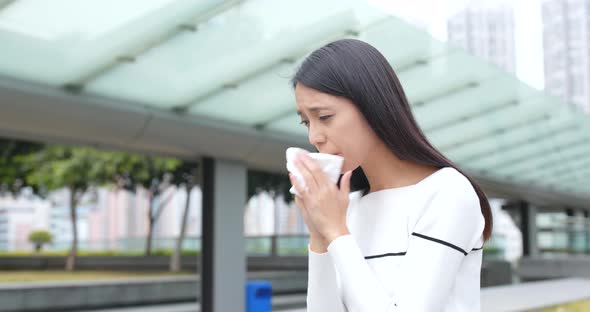 Young Woman sneeze at outdoor