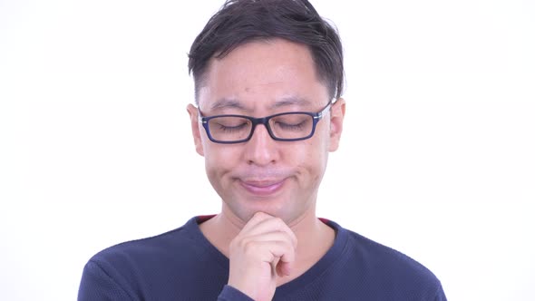 Face of Stressed Japanese Hipster Man Thinking and Looking Down