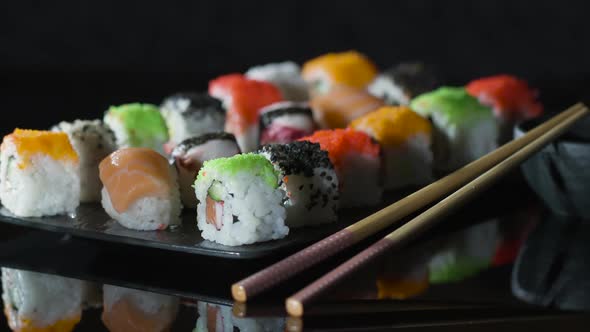 Fresh Japanese Sushi and Maki on a Large Plate with Soy Sauce and Chopsticks.
