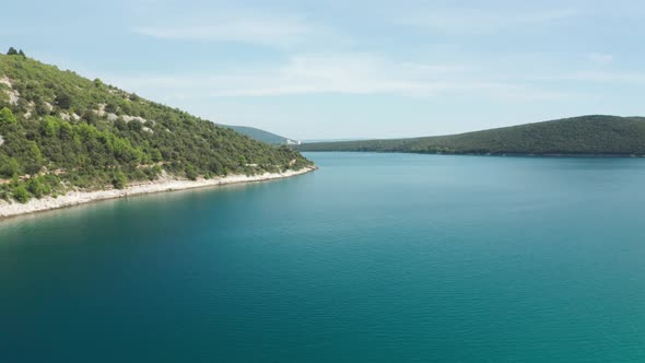 Aerial shot of a lagoon in Croatia near Luca Beach, Istria. Camera tracks slowly to the side.