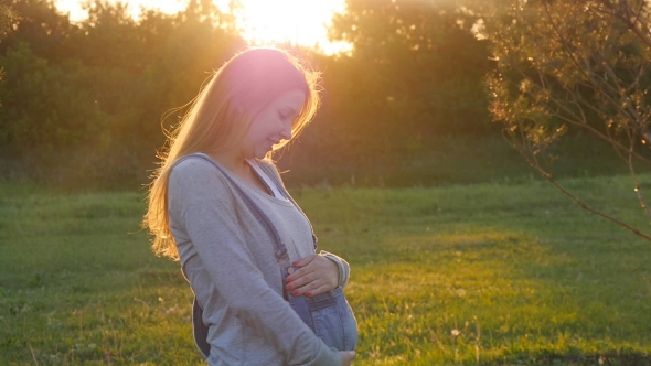 Beautiful Pregnant Woman On Grass