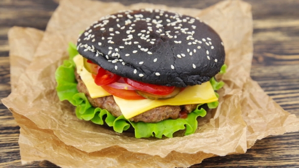 Black Burger On Wooden Table
