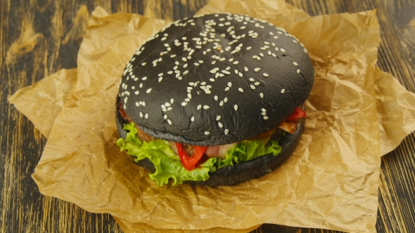 Black Burger On Wooden Table