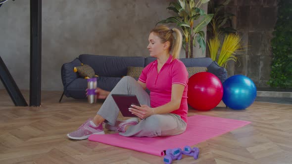 Sporty Woman Video Conferencing with Fitness Trainer