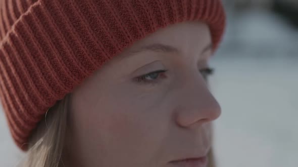 Girl in an Orange Hat in Winter Looks Around and Smiles, Happy Woman