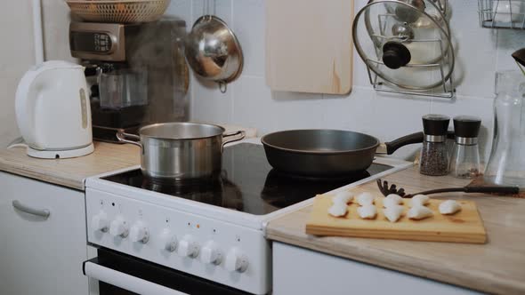 Water Boils in Pot on the Electric Stove in the Kitchen