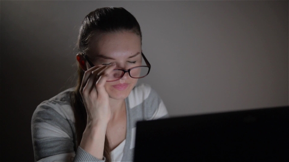 Young Tired Business Woman With Headache Sitting At Computer In Workplace