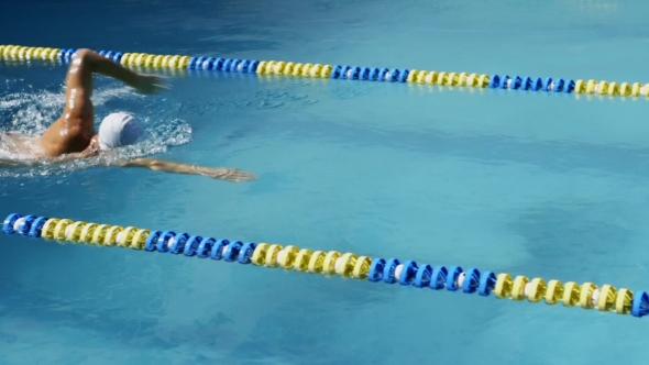 Professional Swimmer Swimming the Crawl in Outdoor Pool