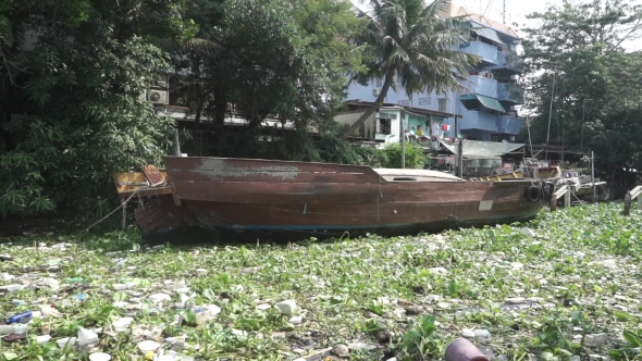 Swinging Moored Old Boat In Polluted Water Of Bangkok