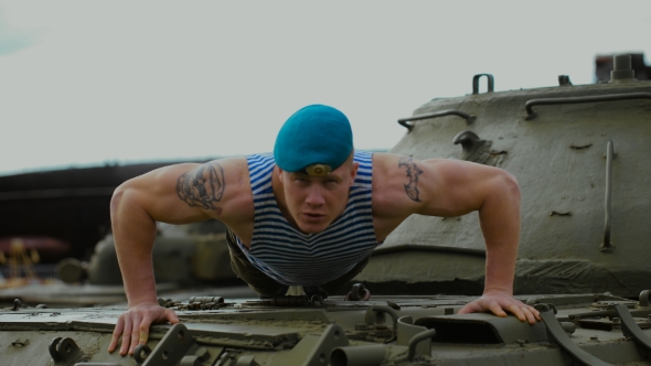 A Soldier In a Blue Beret Doing Push-ups.