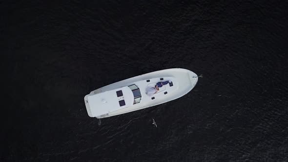 Top Aerial View of Married Couple in a Yacht in Open Sea