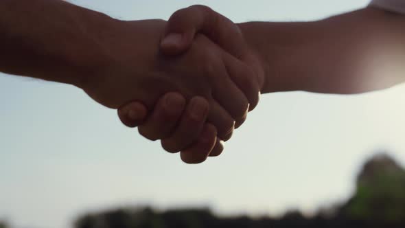 Caucasian People Shaking Hands Outdoors