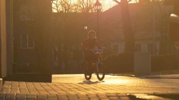 Little Girl Starts to Ride a Bicycle by City