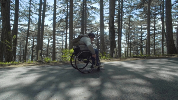 Man Runs His Wheelchair on the Road