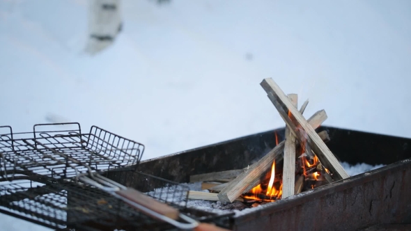 Grating Lying On a Brazier Burning Flames