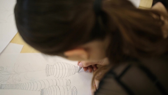 Woman Throughly Paint Vase With Flowers On Sheet Of Paper