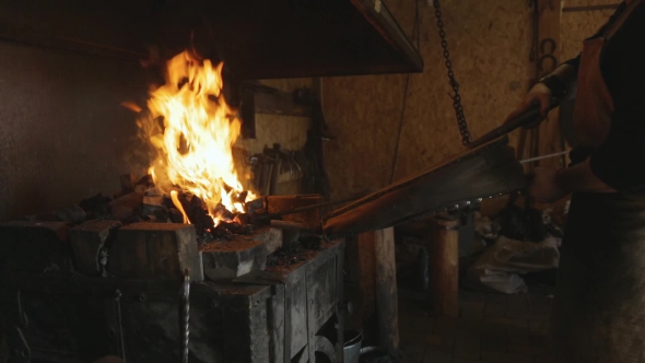Blacksmith Lit Horn Foment Fire With Leather Bellows.