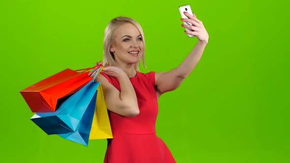 Happy Shopping Woman Makes Selfie on Mobile, Green Screen Studio