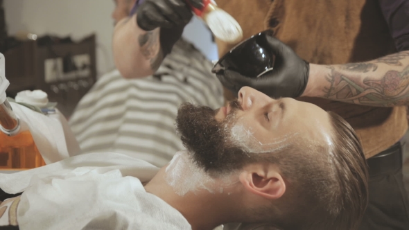 Client During Beard Shaving In Barber Shop