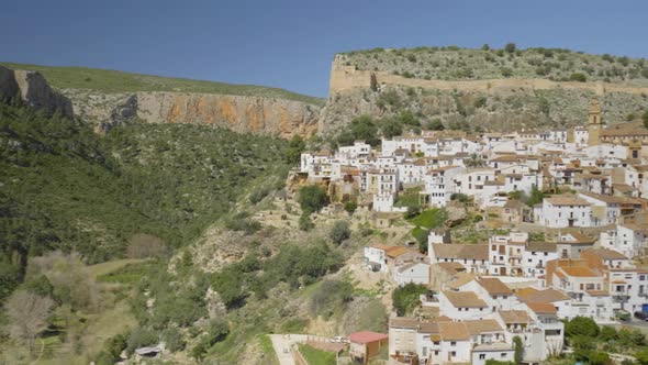 Camera pans over to the reveal the small mountain village of Chulilla