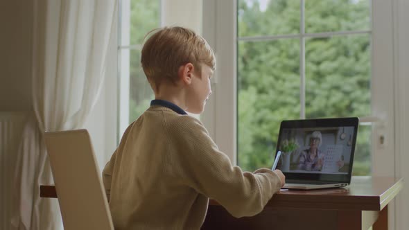 School Boy Studying Math with Senior Teacher Online Using Laptop for Distance Learning at Home