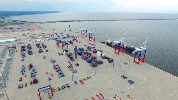 Aerial view of a seaport with cranes, ships, containers and cargo