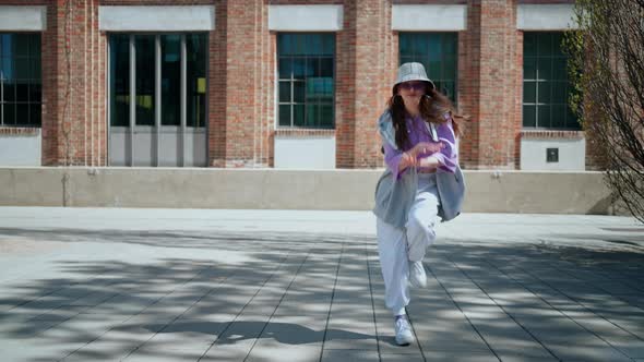 Fashion Cute Woman with Hat Dancing Outside Whit Copy Space