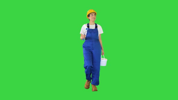 Female House Painter with Paint Brush Walking Looking What to Paint on a Green Screen Chroma Key