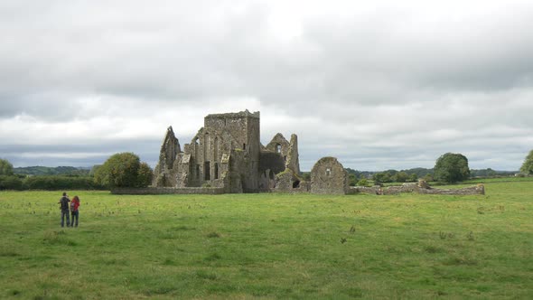 Two people by Hore Abbey monastery in Cashel