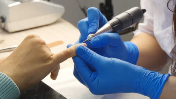 Manicure. The Device Removes The Cuticle