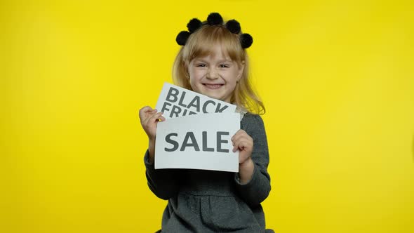 Cheerful Blonde Child Girl Showing Black Friday and Sale Word Advertisement Inscriptions Banners