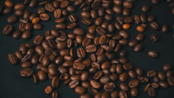 Closeup of Mocha Coffee Beans Fall and Bounce on the Table